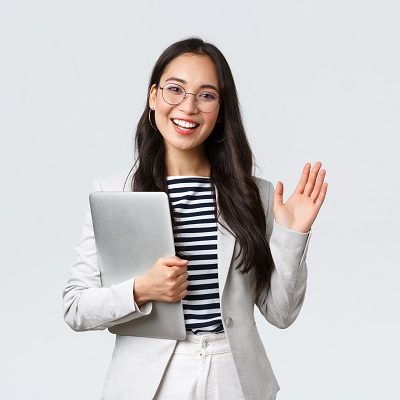 Business, finance and employment, female successful entrepreneurs concept. Friendly smiling office manager greeting new coworker. Businesswoman welcome clients with hand wave, hold laptop.